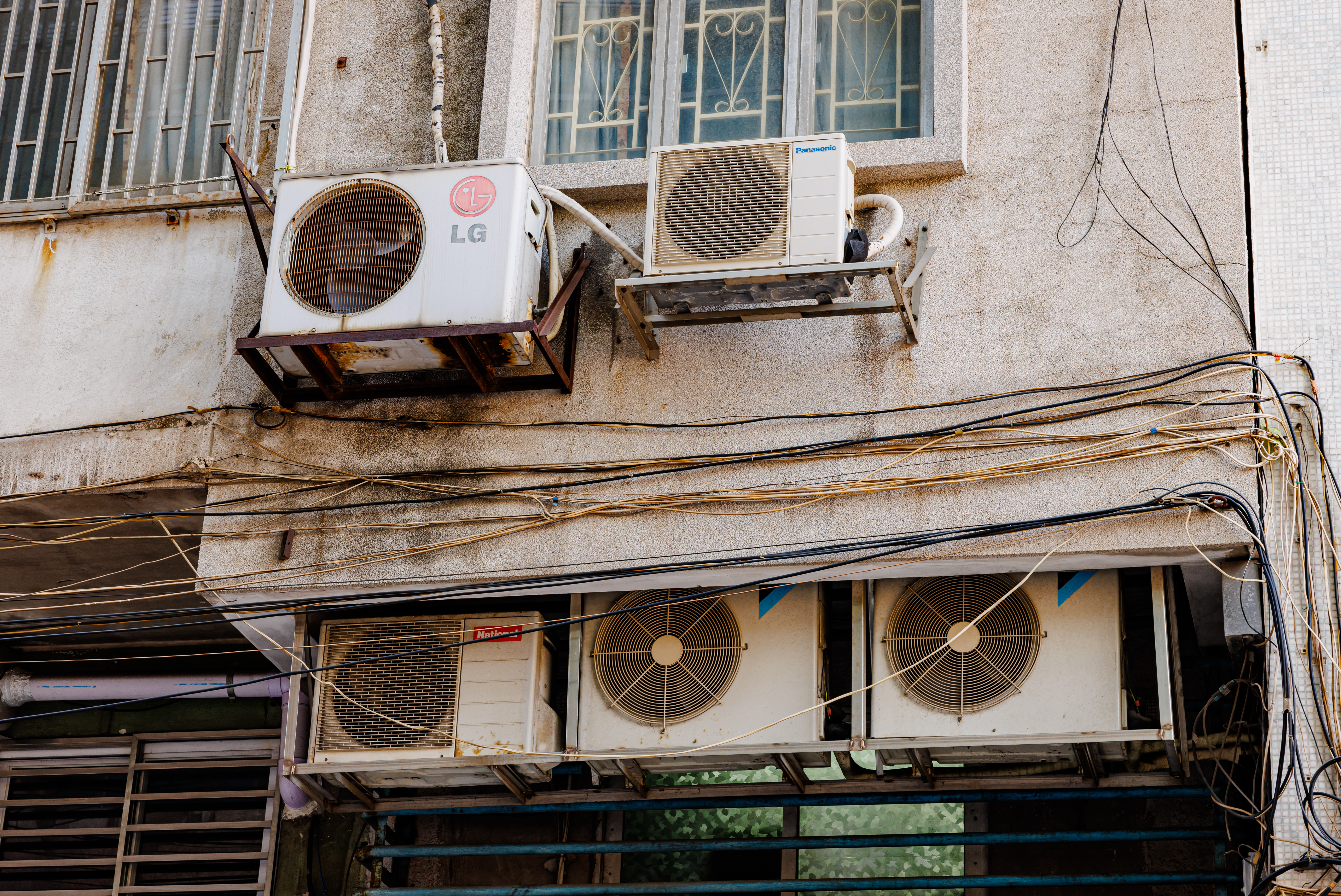 Professional HVAC technician servicing AC unit in Leander TX